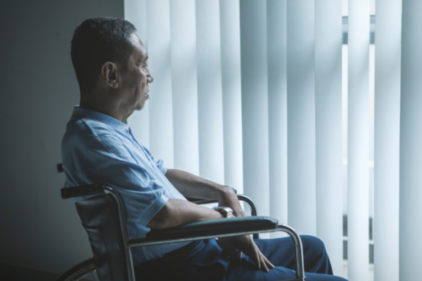 Man looking out window