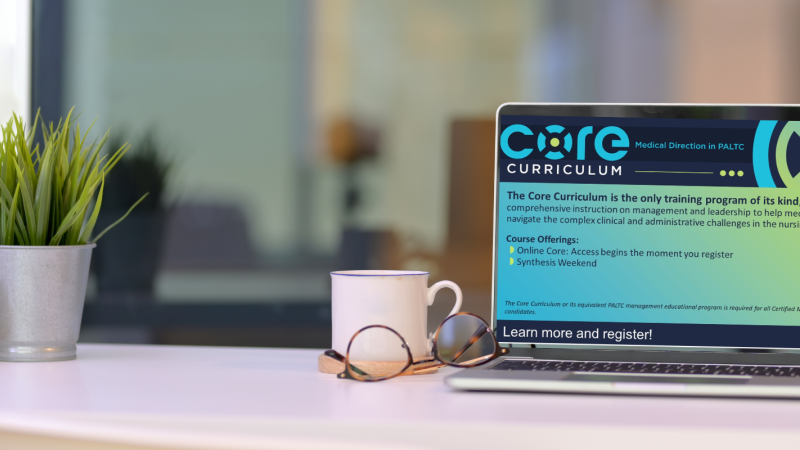 marketing image of a laptop on a desk with a screenshot of an online learning system